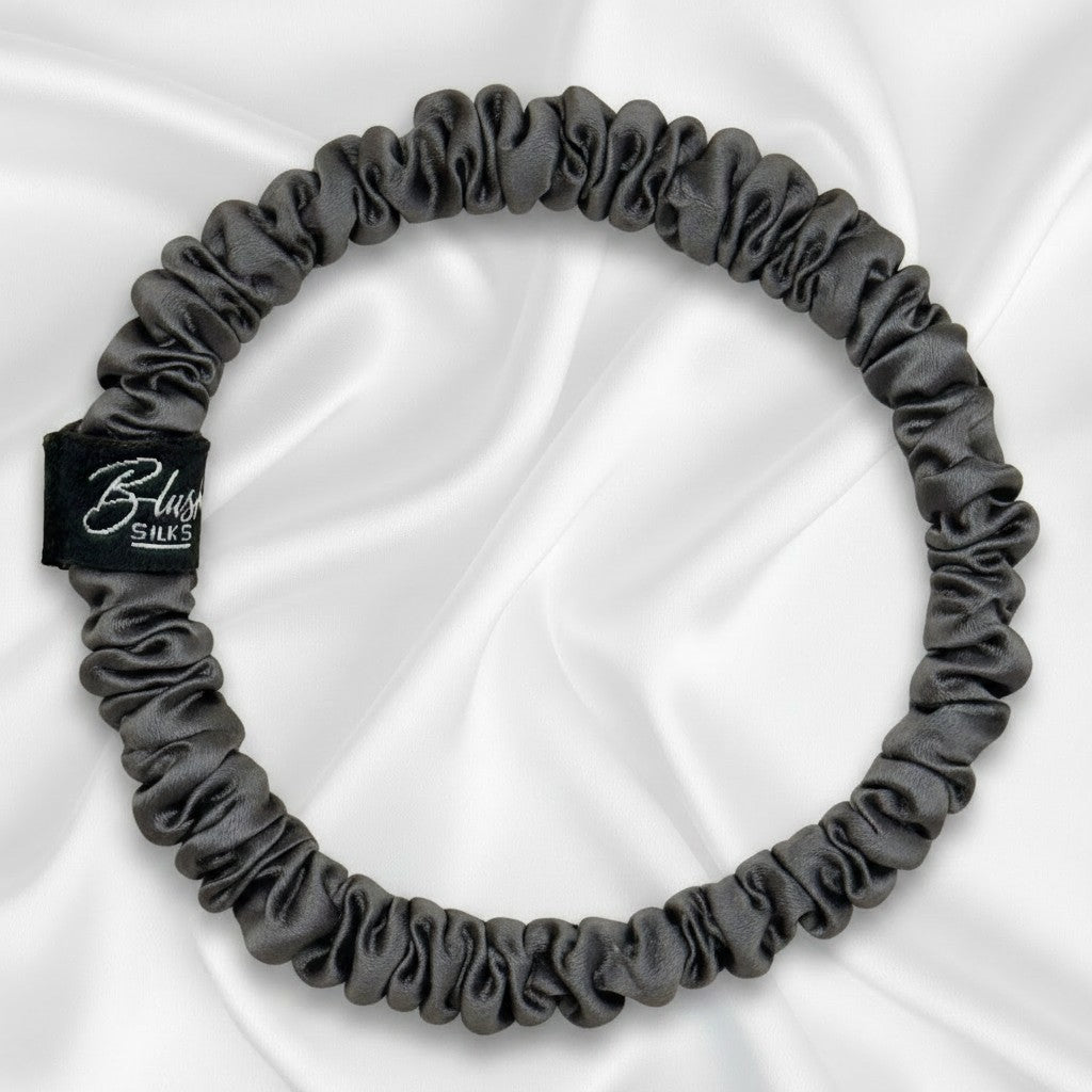 Charcoal grey mini pure mulberry silk scrunchie for a sleek, damage-free neutral hairstyle.