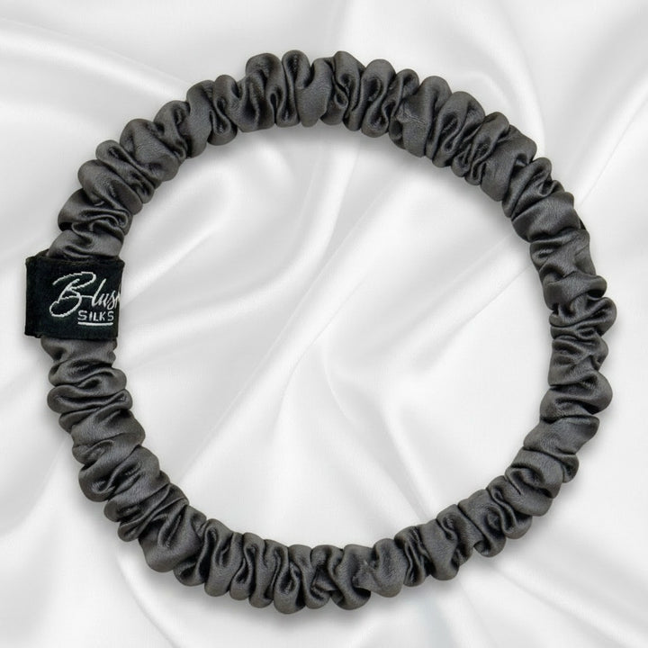 Charcoal grey mini pure mulberry silk scrunchie for a sleek, damage-free neutral hairstyle.