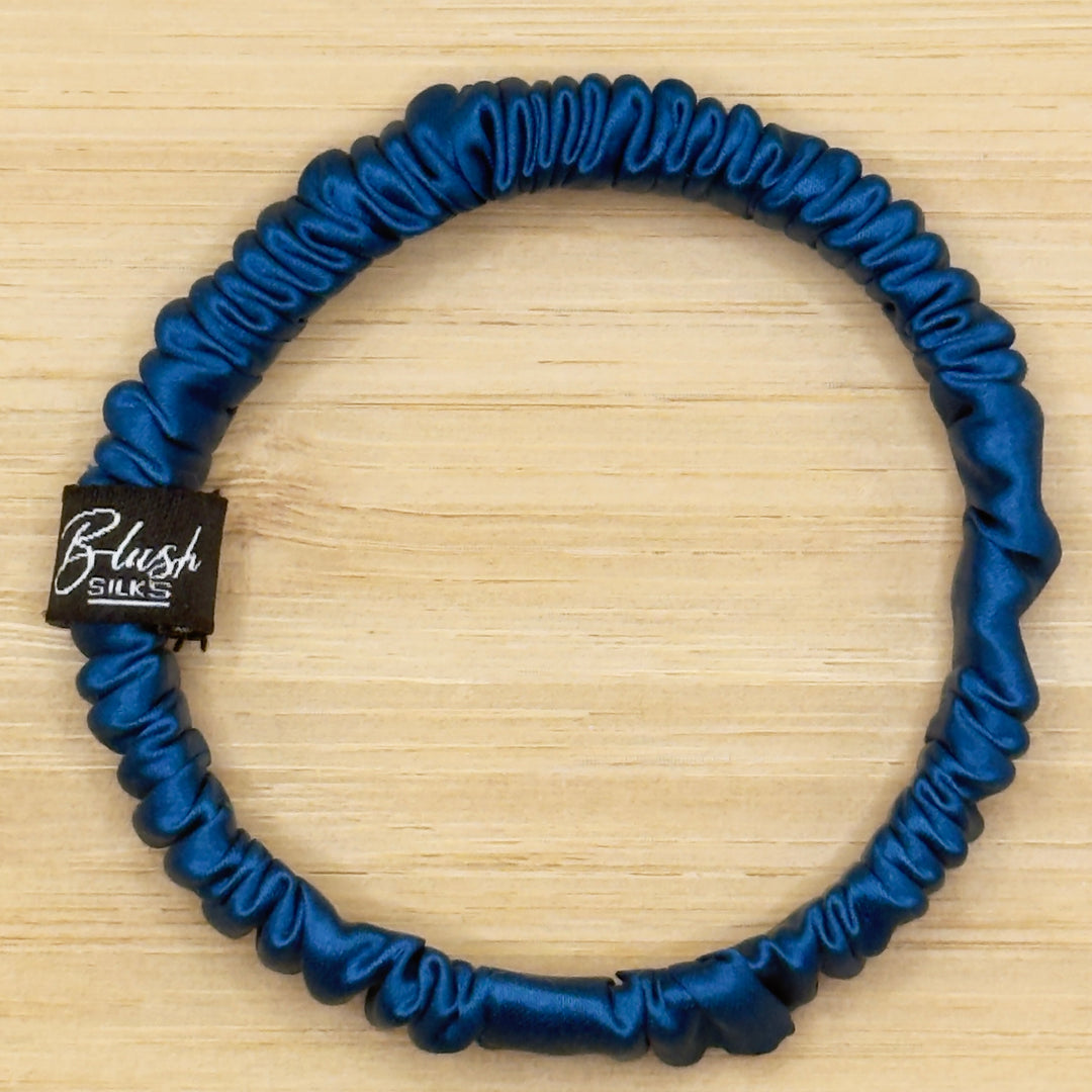 Vibrant cobalt blue mini pure mulberry silk scrunchie for a bold, damage-free ponytail.