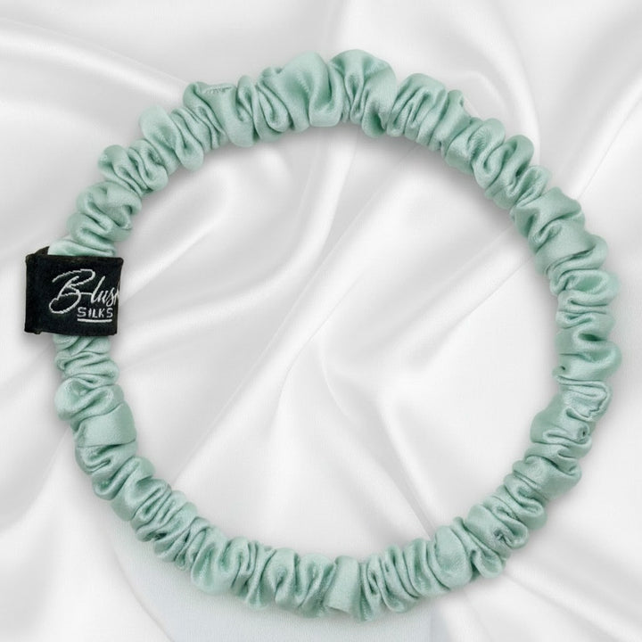 Soft mint green mini pure mulberry silk scrunchie for a gentle, damage-free pastel hairstyle.