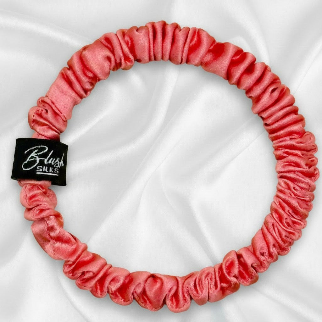 Bright watermelon pink mini pure mulberry silk scrunchie for a fun, damage-free summer hairstyle.