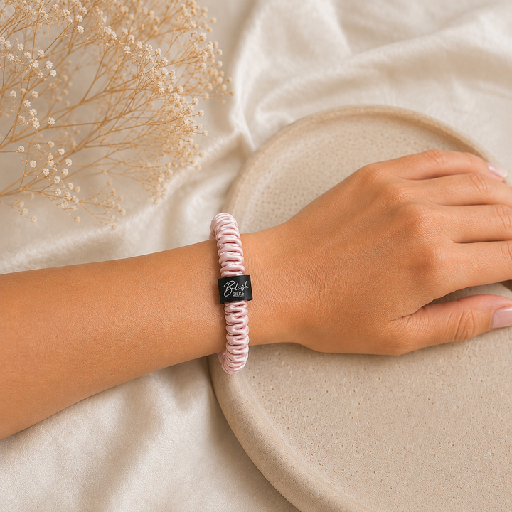 Blush Pink 100% mulberry silk mini scrunchie worn on wrist