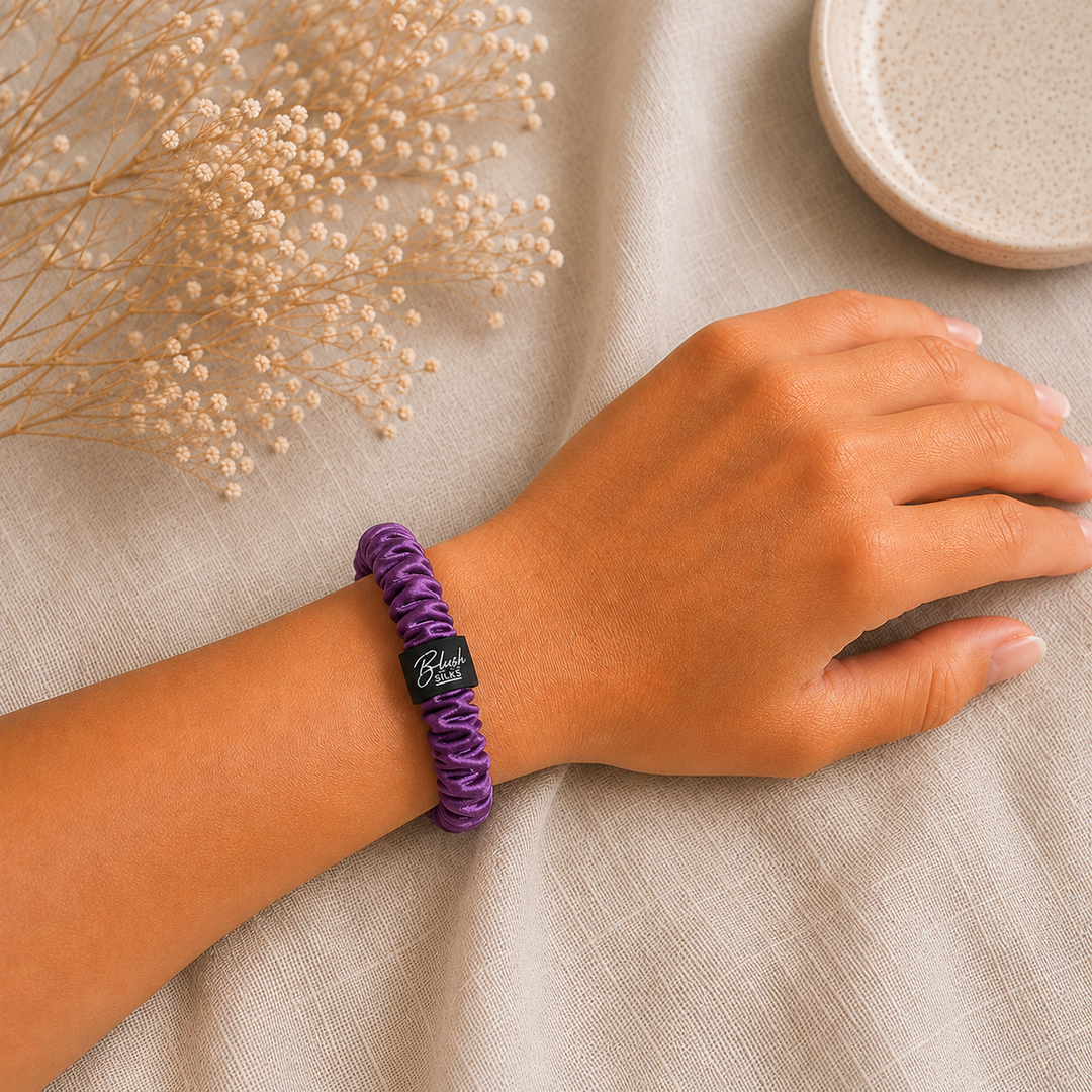 Purple 100% mulberry silk mini scrunchie worn on wrist